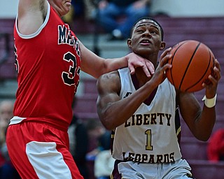 LIBERTY, OHIO - DECEMBER 27, 2017: Liberty's Dre Rushton goes to the basket against Mathews Luke Culp during the first half of their game on Wednesday night at Liberty High School. DAVID DERMER | THE VINDICATOR