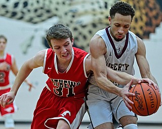 LIBERTY, OHIO - DECEMBER 27, 2017: Liberty's Kevin Code controls the ball while Mathews Zach Rhodanz attempts to knock it out of his control during the second half of their game on Wednesday night at Liberty High School. DAVID DERMER | THE VINDICATOR