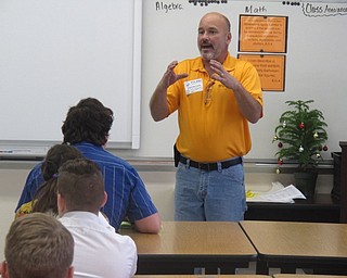 Neighbors | Zack Shively.The exploration day aimed at getting students thinking about their paths into high school and college. Pictured, electrician Dave Coogan spoke to the students about what he does and the importance of a STEM background for many professions.