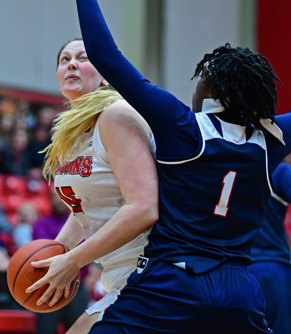 YOUNGSTOWN, OHIO - DECEMBER 28, 2017: Youngstown State's Mary Dunn spins around Detroit's Ashley Miller during the first half of their game on Thursday night at Beeghly Center. Youngstown State won 76-59. DAVID DERMER | THE VINDICATOR