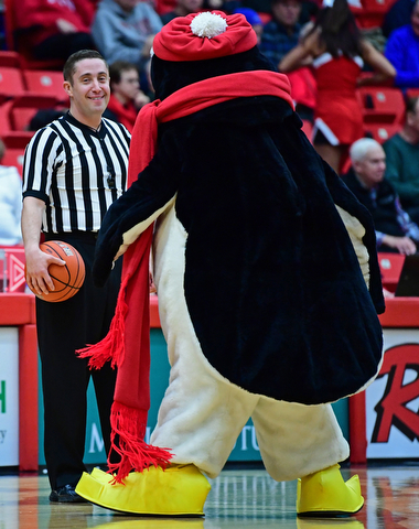 YOUNGSTOWN, OHIO - DECEMBER 28, 2017: Referee Aaron Brooks smiles while Pete the Penguin dances in front of him during a timeout of a game between the Youngstown State Penguins and Detroit Mercy Titans. Youngstown State won 76-59. DAVID DERMER | THE VINDICATOR