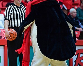 YOUNGSTOWN, OHIO - DECEMBER 28, 2017: Referee Aaron Brooks smiles while Pete the Penguin dances in front of him during a timeout of a game between the Youngstown State Penguins and Detroit Mercy Titans. Youngstown State won 76-59. DAVID DERMER | THE VINDICATOR
