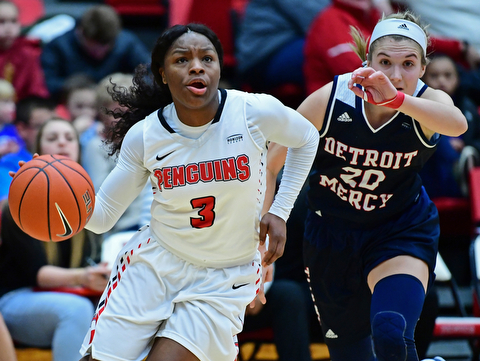 YOUNGSTOWN, OHIO - DECEMBER 28, 2017: Youngstown State's Indiya Benjamin drives on Detroit's Nicole Urbanick during the second half of their game on Thursday night at Beeghly Center. Youngstown State won 76-59. DAVID DERMER | THE VINDICATOR