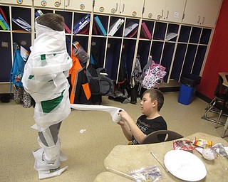 Neighbors | Zack Shively.The PTA organized the winter room parties to give the students a fun day before break. Pictured, students in Ms. Hutchinson's class wrapped each other in toilet paper.