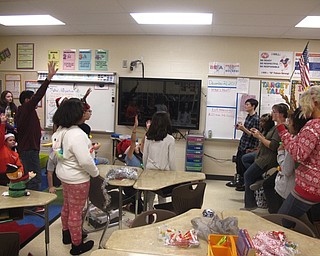 Neighbors | Zack Shively.The parents stayed in the classrooms and helped with the games, crafts and snacks for the Austintown Intermediate winter room parties. Pictured, Ms. Henin's group of students played a trivia game.