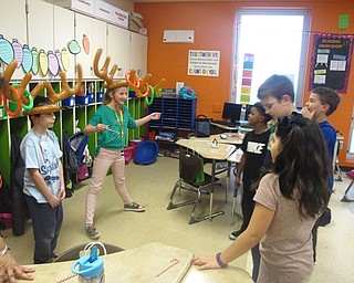 Neighbors | Zack Shively.Students at Austintown Intermediate School celebrated the holidays with a winter room party in all classrooms throughout the school. Pictured, Ms. Noel's students play a ring toss game.