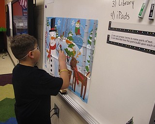 Neighbors | Zack Shviely.The winter classroom parties at Austintown Intermediate School on Dec. 22 featured games, crafts and snacks. Pictured, Ben Melendez attempted to pin the carrot on the snowman.