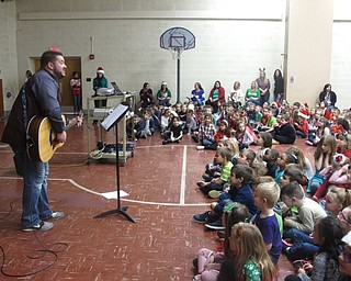 Neighbors | Zack Shively.Joel Monaco sang Christmas songs with the students of Stadium Elementary. He used his guitar to add interesting qualities to the song, such as playing with the tempo of "Feliz Navidad."