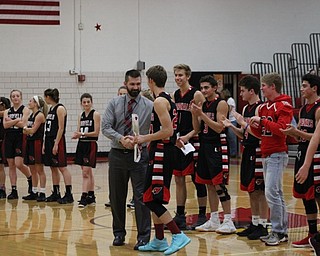 Neighbors | Abby Slanker.Canfield High School boys varsity Head Coach Todd Muckleroy greeted a member of the boys varsity team as both the boys and girls varsity teams were introduced during the Meet the Team Rally on Nov. 16.