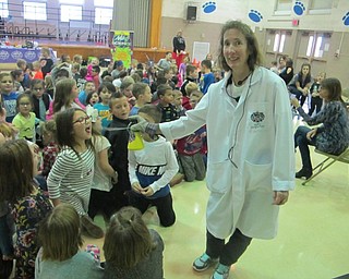 Neighbors | Zack Shively.Marcia Dilling and Lee Snider made a steam that tasted like soda using dry ice. Pictured, Dilling gave the children a taste of their soda steam.