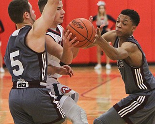 William D. Lewis The Vindicator Fitch'sBlake Baker(3) is hemmed in by Boardman's Mike Melewski(5) and Ryan Archey(2)during 12-29-17 action at Fitch.