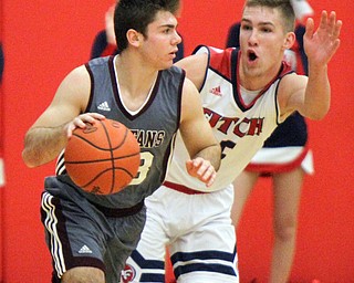 William D. Lewis The Vindicator Boardman's Dom Stilliano(33) drives around Fitch;sCole Constance(5) during 12-29-17 action at Fitch.