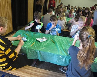 Neighbors | Zack Shively.The students met in the gymnasium to paint their projects. Splash of Elegance provided the school with the ceramics for their event.