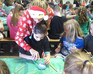 Neighbors | Zack Shively.Art students from the high school came to Dobbins Elementary to help the young students with their projects. THey helped the students get their supplies and place their projects in the designated areas.