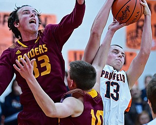 NEW MIDDLETOWN, OHIO - DECEMBER 29, 2017: Springfield's John Ritter grabs a rebound away from South Range's Chris Brooks and Brady White during the first half of their game on Friday night at Springfield High School. DAVID DERMER | THE VINDICATOR