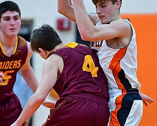 NEW MIDDLETOWN, OHIO - DECEMBER 29, 2017: Springfield's Clay Medvec secures the basketball while colliding with South Range's Brennan Troy during the first half of their game on Friday night at Springfield High School. DAVID DERMER | THE VINDICATOR