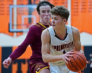 NEW MIDDLETOWN, OHIO - DECEMBER 29, 2017: Springfield's Evan Ohlin looks to pass while being pressured by South Range's Brady White during the second half of their game on Friday night at Springfield High School. DAVID DERMER | THE VINDICATOR