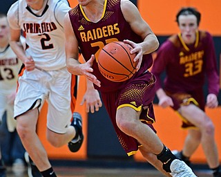 NEW MIDDLETOWN, OHIO - DECEMBER 29, 2017: South Range's Jaxon Anderson dribbles away from Springfield's Drew Clark after a steal during the second half of their game on Friday night at Springfield High School. DAVID DERMER | THE VINDICATOR