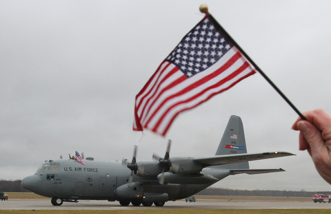 William D. Lewis The Vindicator Well wishers wave flags as  reservists aboard C-130's return from deployment  at YARS  Jan. 18, 2017.