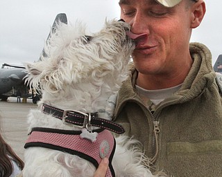 William D. Lewis The Vindicator USAF reserve Lt. John Kirin of Cortland gets a kiss from his dog Roxie after returning from deployment with members of US Air Force reserve unit at YARS  Jan. 18, 2017.