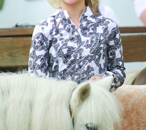     ROBERT K. YOSAY  | THE VINDICATOR..171st Canfield Fair is underway ..  Jewelina Reeveley (ok)  10 of Poland  shows her minature pony in the championship class at the 4-h ring