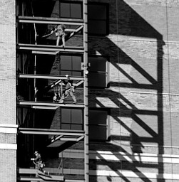   ROBERT K YOSAY  | THE VINDICATOR..Ironworkers build an outside stairwell with a good reflection of work on the wall as work continues on the Stambaugh Builiding being converted to a Double Tree by Hilton  owned by NYO property group..-30-