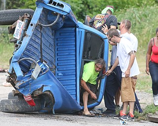     ROBERT K. YOSAY  | THE VINDICATOR..a two vehicle wreck at  Hillman and Myrtle  had a vehicle on its side.. as neighbors helped people out of the truck..  the wreck involved a pickup truck and a car  just after noon today (thursday)