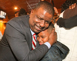 William D Lewis The Vindicator Tito Brown is all smiles as he hugs his son Quentin, 7, during victory party at MVR 11-7-2-17.