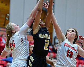 YOUNGSTOWN, OHIO - DECEMBER 30, 2017: Oakland's  Korrin Taylor grabs a rebound away from Youngstown State's Morgan Brunner and McKenah Peters during the second half of their game on Saturday afternoon at Beegley Center. Oakland won 58-48. DAVID DERMER | THE VINDICATOR