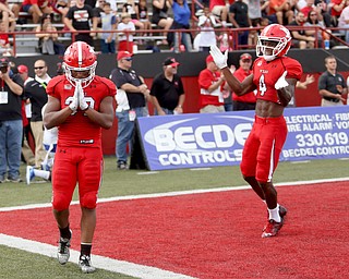 Youngstown State University tail back Tevin McCaster (37) places his hands together after scoring a touchdown as he is congratulated by Youngstown State University wide receiver Damoun Patterson (4) in the first quarter as Youngstown State takes on Central Connecticut State, Saturday, Sept. 16, 2017, at Stambaugh Stadium in Youngstown. Youngstown State won 59-9...(Nikos Frazier | The Vindicator)..