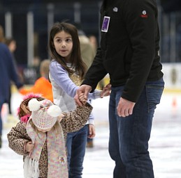 Dustin Rivera of Girard ice skates with his daughters, Camille(3)(left) and Lilah(7)(center) during First Night Youngstown, Sunday, Dec. 31, 2017, at the Covelli Centre in Youngstown. ..(Nikos Frazier | The Vindicator)