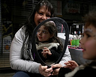 Ariana McDonough(5) of Canfield gets a reindeer face painted by Maria Jones of New Castle during First Night Youngstown, Sunday, Dec. 31, 2017, at LOCATION in Youngstown. ..(Nikos Frazier | The Vindicator)