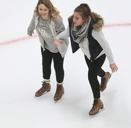 Mia Moran(17) and Marina Sepulveda(13) hold hands as they ice skate during First Night Youngstown, Sunday, Dec. 31, 2017, at LOCATION in Youngstown. ..(Nikos Frazier | The Vindicator)