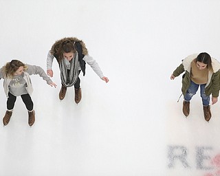 (from left) Mia Moran(17), Marina Sepulveda(13) and Helena Sepulveda(17) ice skate during First Night Youngstown, Sunday, Dec. 31, 2017, at the Covelli Centre in Youngstown. ..(Nikos Frazier | The Vindicator)