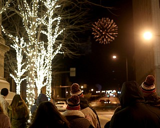 People watch the fireworks display during First Night Youngstown, Sunday, Dec. 31, 2017, in downtown Youngstown. ..(Nikos Frazier | The Vindicator)