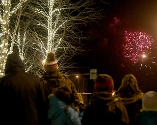 People watch the fireworks display during First Night Youngstown, Sunday, Dec. 31, 2017, in downtown Youngstown. ..(Nikos Frazier | The Vindicator)