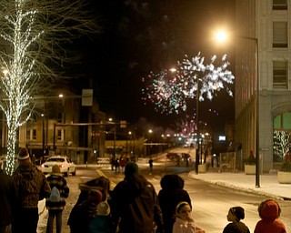 People watch the fireworks display during First Night Youngstown, Sunday, Dec. 31, 2017, in downtown Youngstown. ..(Nikos Frazier | The Vindicator)