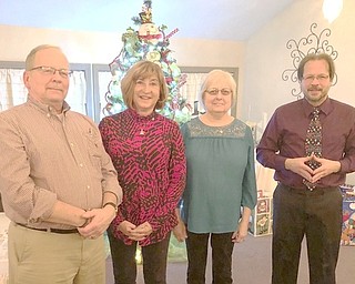 The Canfield Lions recently celebrated Christmas with a party at A La Cart Catering in Canfield. Two new members were inducted by Past District Governor Ted Filmer. Above, from left, are Kevin Seguin and Laura Sullivan, new members, and their sponsors, Marian Zickefoose and Mike Hoffman.