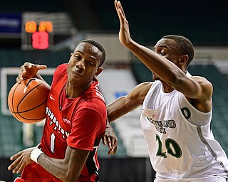 YOUNGSTOWN, OHIO - JANUARY 1, 2018: Youngstown State's Braun Hartfield loses control of the ball while driving on Clevaldn State's Bobby Word during the second half of their game on Saturday afternoon at the Wolstein Center. Youngstown State won 80-77. DAVID DERMER | THE VINDICATOR