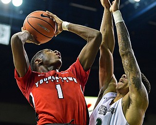 YOUNGSTOWN, OHIO - JANUARY 1, 2018: Youngstown State's Braun Hartfield puts up a shot over Cleveland State's Anthony Wright during the second half of their game on Saturday afternoon at the Wolstein Center. Youngstown State won 80-77. DAVID DERMER | THE VINDICATOR