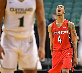 YOUNGSTOWN, OHIO - JANUARY 1, 2018: Youngstown State's Jaylen Benton celebrates after hitting a three point shot during the second half of their game on Saturday afternoon at the Wolstein Center. Youngstown State won 80-77. DAVID DERMER | THE VINDICATOR..Cleveland State's Kasheem Thomas pictured.