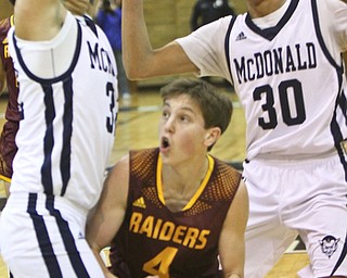 William D. Lewis the Vindicator McDonalds Matthew Beedle(32) and Braedon Poole()30)  surround South Range's Brennan Foy during 1-2-18 action at McDonald.