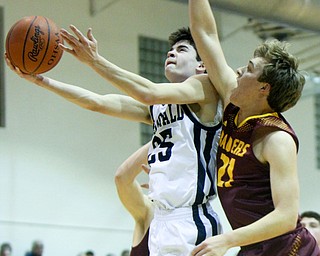 William D. Lewis the Vindicator McDonalds Zach Rasile(25) shoots past South Range's Branon Youngs(21) during 1-2-18 action at McDonald.
