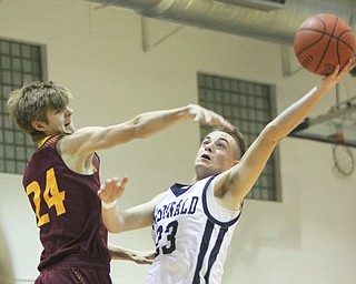 William D. Lewis the Vindicator McDonalds Jake Portalese(33) shoots around south range's Sam Brooks(24)during 1-2-18 action at McDonald.