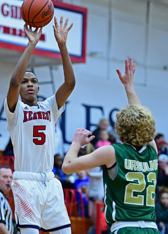 WARREN, OHIO - JANUARY 2, 2017: JFK's Tyler James shoot over Ursuline's Vince Armini during the first half of their game on Tuesday night at Warren JFK High School. DAVID DERMER | THE VINDICATOR