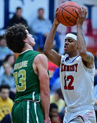 WARREN, OHIO - JANUARY 2, 2017: JFK's Byron James goes tot he basket while Ursuline's Luko DiPala sets up to take a charge during the first half of their game on Tuesday night at Warren JFK High School. DAVID DERMER | THE VINDICATOR
