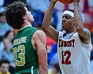 WARREN, OHIO - JANUARY 2, 2017: JFK's Byron James goes tot he basket while Ursuline's Luko DiPala sets up to take a charge during the first half of their game on Tuesday night at Warren JFK High School. DAVID DERMER | THE VINDICATOR