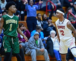 WARREN, OHIO - JANUARY 2, 2017: JFK's Byron James stares down Ursuline's Deshaun Harris after he hit a three point basket during the first half of their game on Tuesday night at Warren JFK High School. DAVID DERMER | THE VINDICATOR