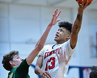 WARREN, OHIO - JANUARY 2, 2017: JFK's Hyland Burton goes tot he basket against Ursuline's Ethan Courtney during the first half of their game on Tuesday night at Warren JFK High School. DAVID DERMER | THE VINDICATOR