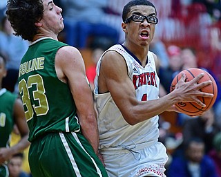 WARREN, OHIO - JANUARY 2, 2017: JFK's B.J. Williams drives to the basket against Ursuline's Luko DiPala during the first half of their game on Tuesday night at Warren JFK High School. DAVID DERMER | THE VINDICATOR